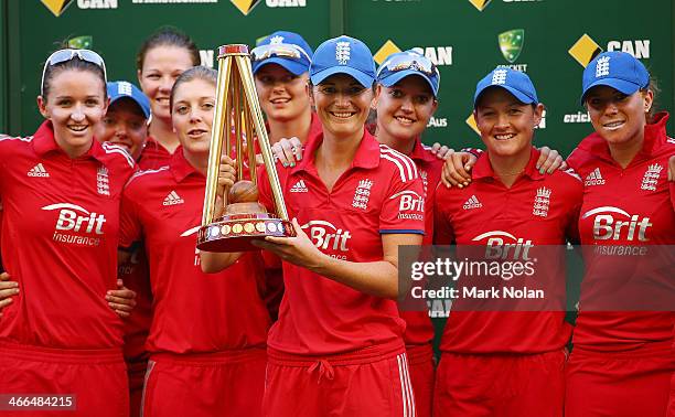 England captain Charlotte Edwards poses with the team and the trophy after game three of the Women's International Twenty20 series between Australia...