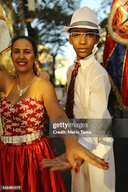 Revelers pose while marching in the first street parade of the 2014 Carnival season through the historic Afro-Brazilian port district during the...