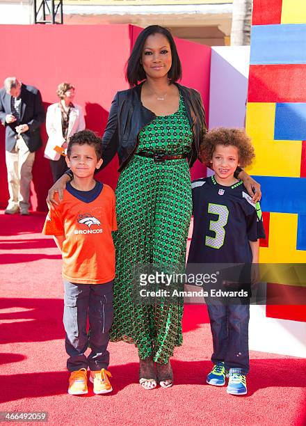 Actress Garcelle Beauvais and her sons arrive at the Los Angeles premiere of "The Lego Movie" at the Regency Village Theatre on February 1, 2014 in...