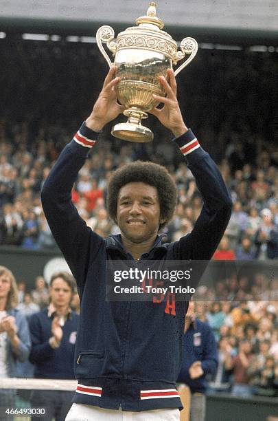 Arthur Ashe victorious with trophy after winning Finals match vs USA Jimmy Connors at All England Club. London, England 7/7/1975 CREDIT: Tony Triolo