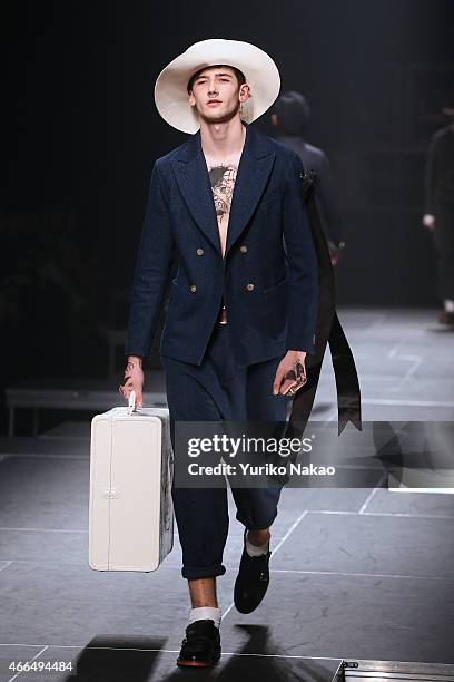 Model showcases designs on the runway during the TAKEO KIKUCHI show as part of Mercedes Benz Fashion Week TOKYO 2015 A/W at Shibuya Hikarie on March...