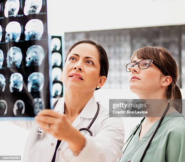 Doctors looking at mri x-rays in clinic