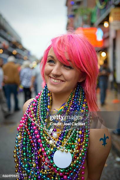 smiling woman wearing numerous beads at mardi gras - mardi gras beads stock pictures, royalty-free photos & images
