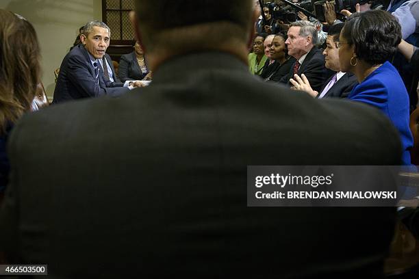 School system superintendents and others listen as US President Barack Obama speaks after a meeting with the Council of the Great City Schools...