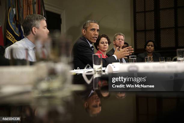 President Barack Obama speaks about federal education funding during a meeting in the Roosevelt Room of the White House with a group of...