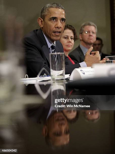 President Barack Obama speaks about federal education funding during a meeting in the Roosevelt Room of the White House with a group of...