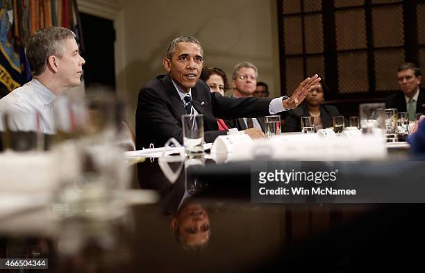 President Barack Obama speaks about federal education funding during a meeting in the Roosevelt Room of the White House with a group of...