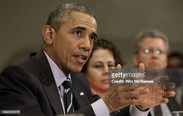 President Barack Obama speaks about federal education funding during a meeting in the Roosevelt Room of the White House with a group of...