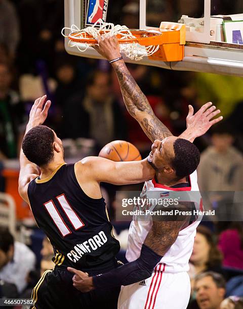 The Portland Red Claws forward Romero Osby dunks the ball against Erie Bayhawks forward Drew Crawford during D League action at the Expo in Portland...