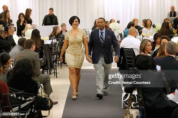 Angela Rossum and Allen Rossum walk the runway at the Saks Fifth Avenue And Off The Field Players' Wives Association Charitable Fashion Show on...