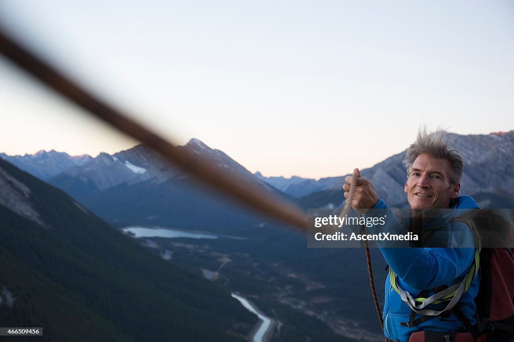 Climber pulls rope tight for teammate