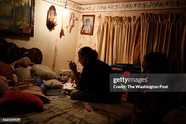 Sandy Fletcher and her granddaughter Shawnetell Allenee Combs spend time together in the bedroom of their mobile home on Thursday, November 21, 2013...