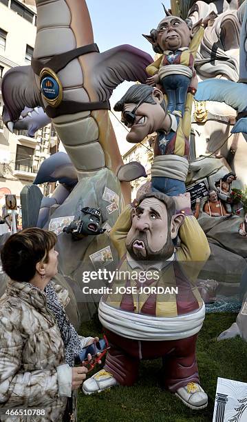 Woman looks at a "ninot" representing President of pro-independence Esquerra Republicana political party Oriol Junquera , regional president of...