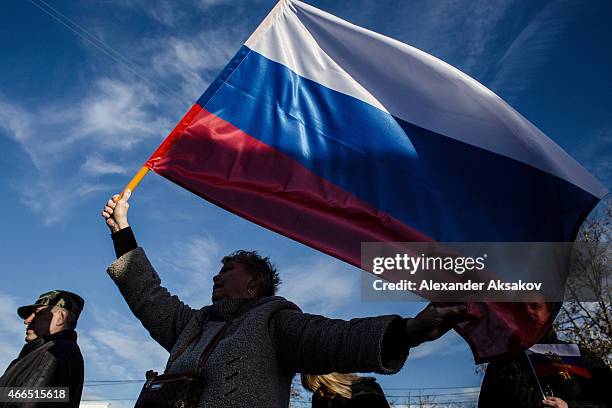 Crimeans wave Russian flags as they celebrate the first anniversary of the referendum on March 16, 2015 in Sevastopol, Crimea . Today marks the first...