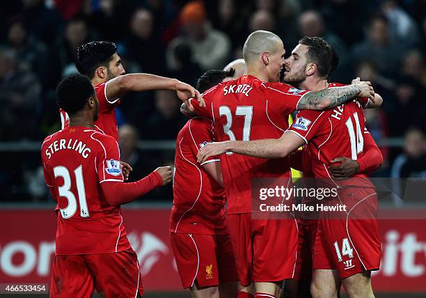 Jordan Henderson of Liverpool celebrates the opening goal with team mates during the Barclays Premier League match between Swansea City and Liverpool...