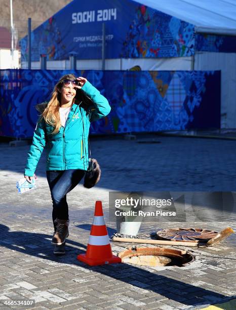 Torah Bright of Australia steps around a man hole after an Australian Olympic Team Snowboard and Freestyle Press Conference at Gorki Press Centre on...
