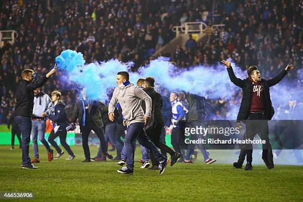 Reading fans celebrate on the pitch after the FA Cup Quarter Final Replay match between Reading and Bradford City at Madejski Stadium on March 16,...