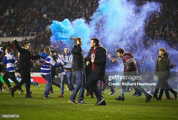 Reading fans celebrate on the pitch after the FA Cup Quarter Final Replay match between Reading and Bradford City at Madejski Stadium on March 16,...