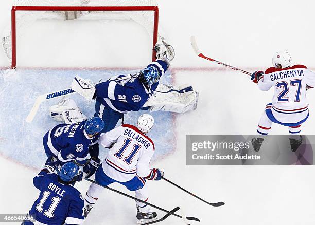 Goalie Ben Bishop of the Tampa Bay Lightning makes a save against Alex Galchenyuk of the Montreal Canadiens during the first period at the Amalie...