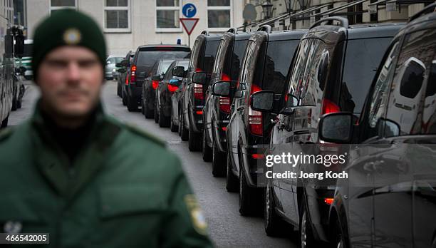 Policeman passes a long row of limousines which are waiting for guests leaving the 50th Munich Security Conference in front of the Bayerischer Hof...
