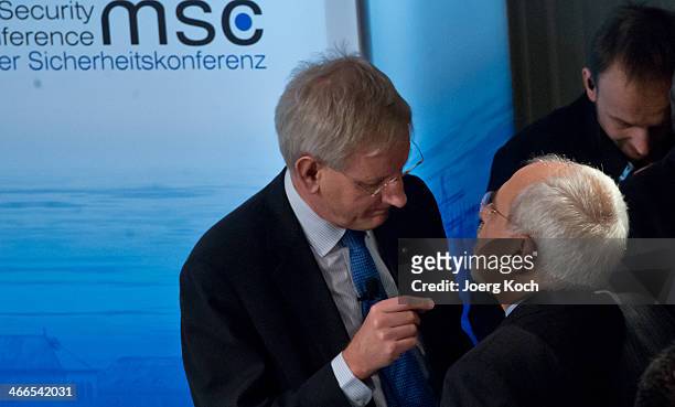 The Swedish Foreign Minister Carl Bildt and Iranian Foreign Minister Mohammed Javad Zarif meet during the 50th Munich Security Conference in the...