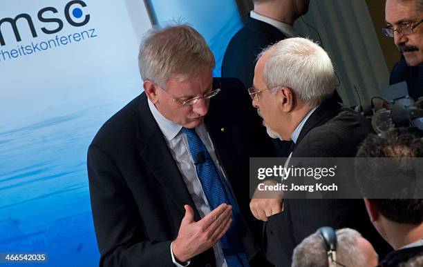 Swedish Foreign Minister Carl Bildt and Iranian Foreign Minister Mohammed Javad Zarif meet during the 50th Munich Security Conference in the...