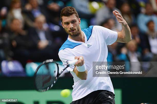 Daniel Brands of Germany plays a forehand in his match against Roberto Bautista Agut of Spain on day 3 of the Davis Cup First round match between...