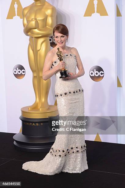 Actress Julianne Moore, with the award for best actress for 'Still Alice' poses in the press room during the 87th Annual Academy Awards at Loews...