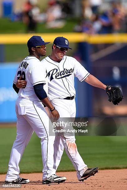 Rymer Liriano and Hunter Renfroe of the San Diego Padres walk off the field after the final out in the game against the Texas Rangers at the Peoria...