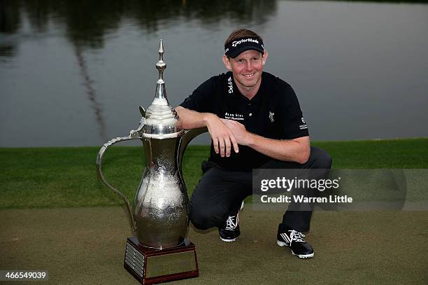 Stephen Gallacher of Scotland poses wih the trophy after winning the 2014 Omega Dubai Desert Classic on the Majlis Course at the Emirates Golf Club...