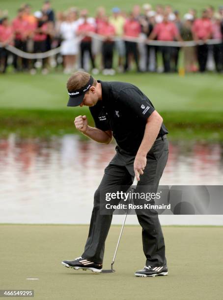 Stephen Gallacher of Scotland celebrates after holing his putt on the 18th green during the final round of the Omega Dubai Desert Classic on the...