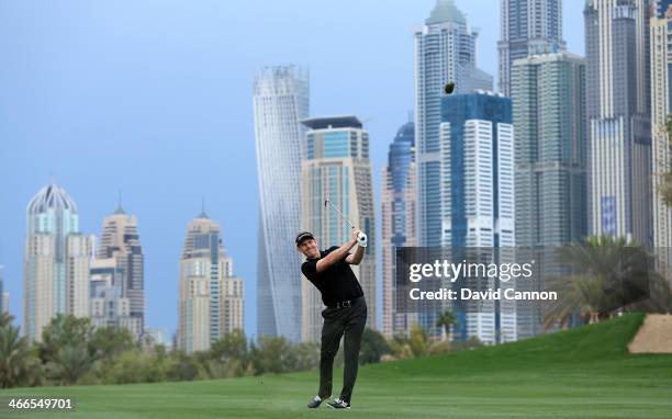 Stephen Gallacher of Scotland plays his second shot at the par 5, 13th hole during the final round of the 2014 Omega Dubai Desert Classic on the...