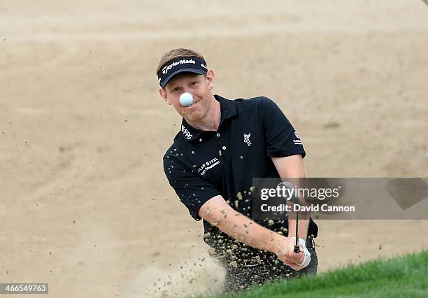 Stephen Gallacher of Scotland plays his second shot at the par 3, 15th hole during the final round of the 2014 Omega Dubai Desert Classic on the...