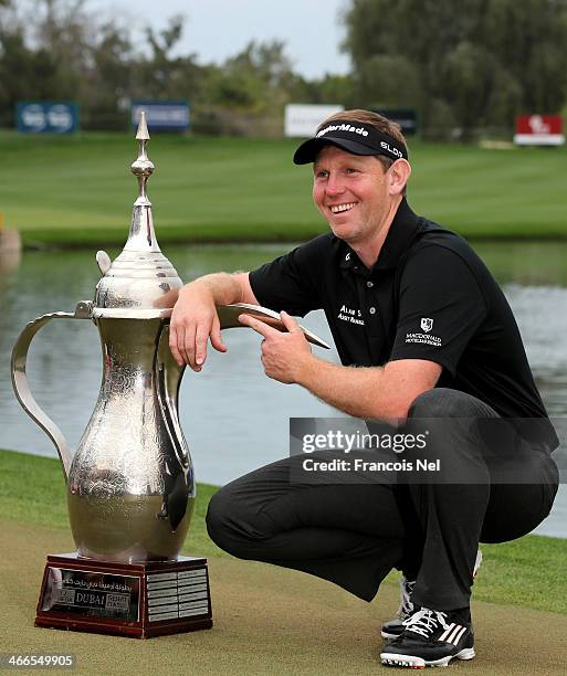 Stephen Gallacher of Scotland poses wih the trophy after winning the Omega Dubai Desert Classic on the Majlis Course at the Emirates Golf Club on...