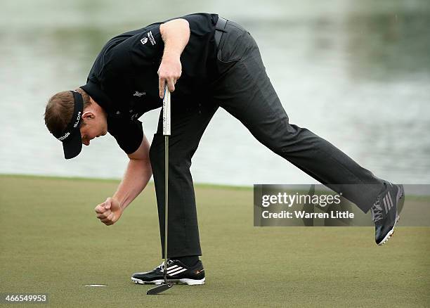 Stephen Gallacher of Scotland celebrates winning the 2014 Omega Dubai Desert Classic on the Majlis Course at the Emirates Golf Club on February 2,...