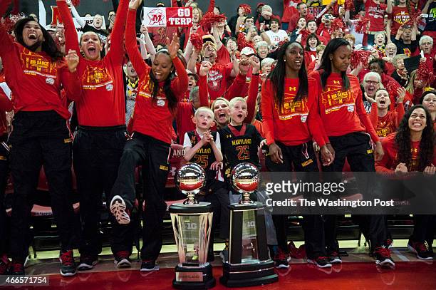 Coach Brenda Frese, with twins Markus, left, and Tyler, and the Maryland women's basketball team react to their NCAA number one seeding in the...