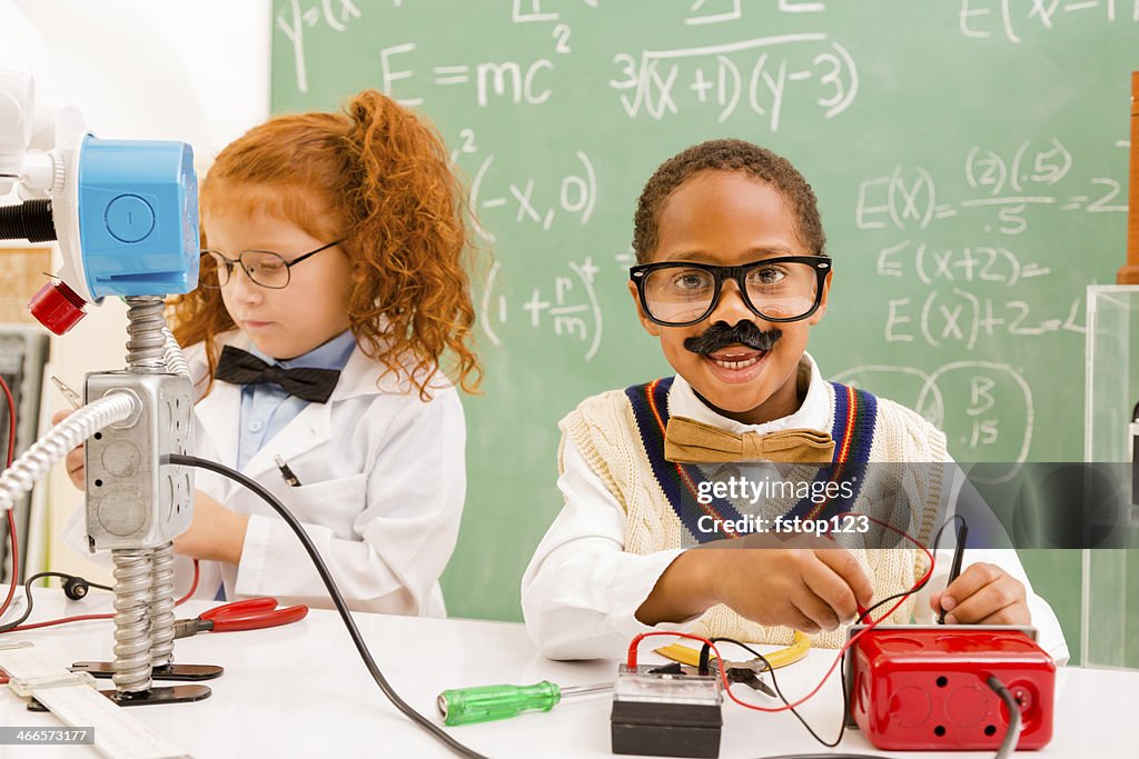 Education: Retro revival children making robot in science lab.