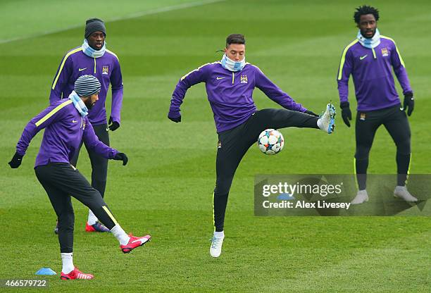Gael Clichy, Yaya Toure, Samir Nasri and Wilfred Bony in action during a Manchester City training session ahead of the UEFA Champions League round of...