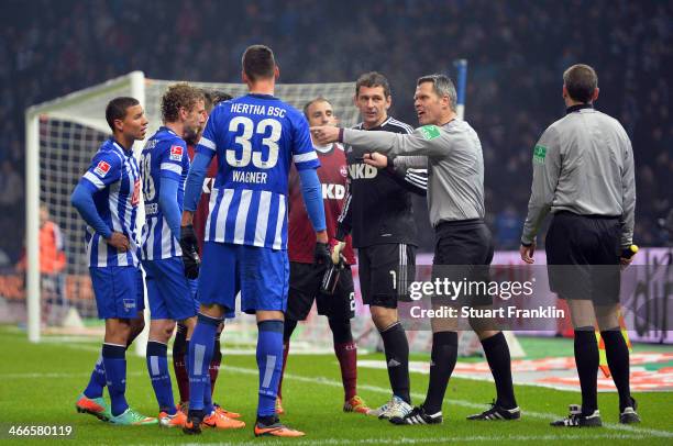 The Referee Michael Weiner talks to the players during the Bundesliga match between Hertha BSC and 1. FC Nuernberg at Olympiastadion on February 2,...