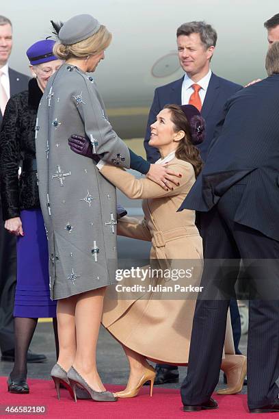 Crown Princess Mary of Denmark curtsy's to Queen Maxima of the Netherlands, at Copenhagen Airport at the start of a Dutch State visit to Denmark on...