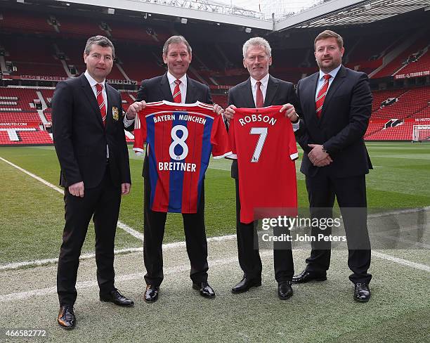 Manchester United Legends Bryan Robson and Denis Irwin and Group Managing Director Richard Arnold pose with Bayern Munich Legend Paul Breitner ahead...