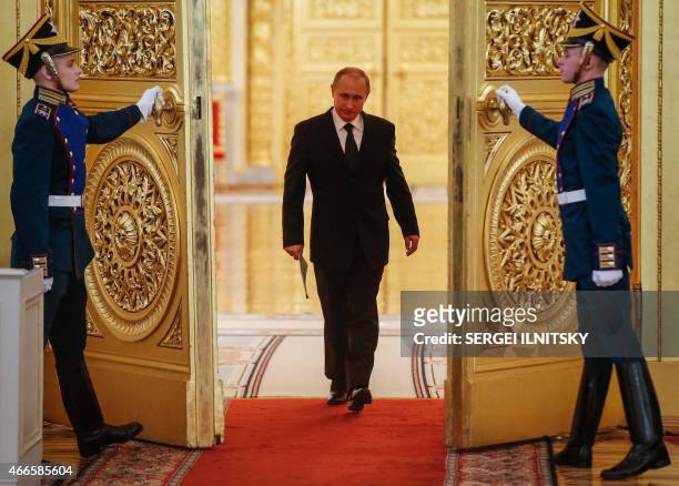 Russian President Vladimir Putin enters a hall before a meeting of the Victory Organizing Committee at the Kremlin in Moscow on March 17, 2015. The...