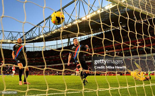 Danny Gabbidon, Joel Ward and Julian Speroni of Crystal Palace look on as Alex Oxlade-Chamberlain of Arsenal's effort hits the back of the net to...