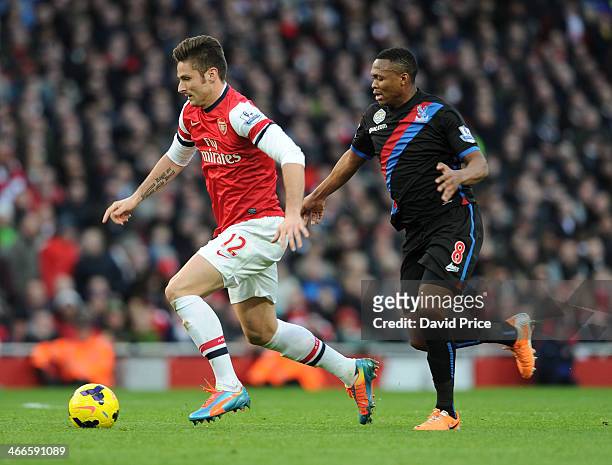 Olivier Giroud of Arsenal takes on Kagisho Dikgacoi of Palace during the match between Arsenal and Crystal Palace in the Barclays Premier League at...