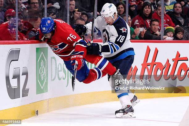 Bryan Little of the Winnipeg Jets body checks P.K. Subban of the Montreal Canadiens during the NHL game at the Bell Centre on February 2, 2014 in...