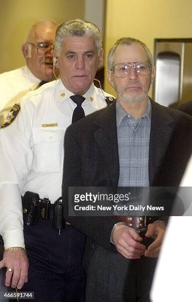 Robert Durst is escorted in handcuffs through the Northampton court house in Easton, Penn. Durst is a suspect in his wife's disappearance 19 years...