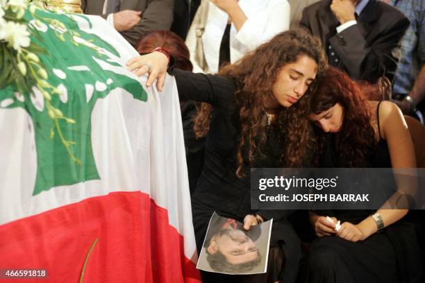 Liana and Maissaa mourn by the coffin of their father, murdered columnist Samir Kassir who regularly wrote virulent articles against Syria's...