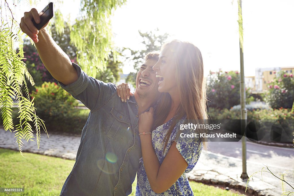 Happy couple making selfie at sunrise