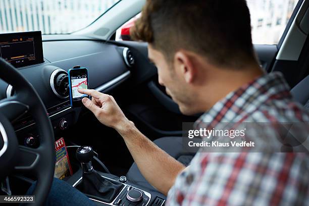 man using smartphone as gps navigation for a car - global positioning system stock pictures, royalty-free photos & images