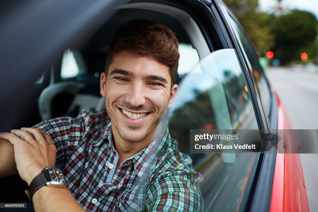 Man Sitting In Red Car And Laughing High-Res Stock Photo - Getty Images